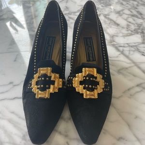 Stuart Weitzman black suede heels with gold buckles and brass trim